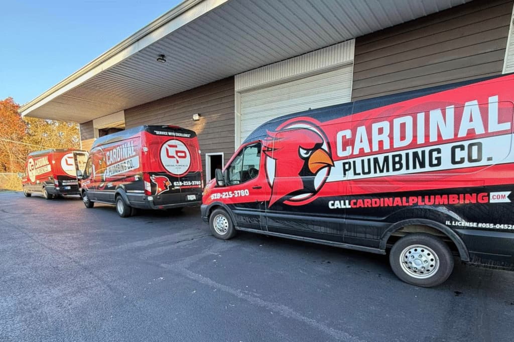 Cardinal Plumbing Co van showcasing vibrant wrap design with logo and service details for easy identification.